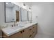 Spacious bathroom with dual sinks, framed mirrors and white countertops at 7528 E Windrose Dr, Scottsdale, AZ 85260