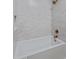 A tub-shower combination with white subway tile, bronze fixtures, and a built-in toiletry niche at 7528 E Windrose Dr, Scottsdale, AZ 85260