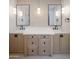 Bathroom featuring dual sinks with wood cabinets, white countertops, and modern lighting at 7528 E Windrose Dr, Scottsdale, AZ 85260
