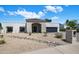 Beautiful modern home exterior with rock landscaping and elegant stone entryway at 7528 E Windrose Dr, Scottsdale, AZ 85260