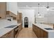 Stylish kitchen with stainless steel appliances, white countertops, and modern cabinetry at 7528 E Windrose Dr, Scottsdale, AZ 85260