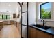 Modern kitchen featuring wood cabinets, stainless steel appliances, and black countertop at 7528 E Windrose Dr, Scottsdale, AZ 85260