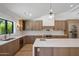 Open-concept kitchen with wood cabinets, stainless steel appliances and a large center island at 7528 E Windrose Dr, Scottsdale, AZ 85260