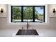 Bright kitchen sink with pool view, features a gooseneck faucet and marble counter top at 7528 E Windrose Dr, Scottsdale, AZ 85260