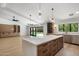 Open floor plan with kitchen island, stainless steel appliances and backyard views at 7528 E Windrose Dr, Scottsdale, AZ 85260