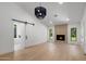 Bright open living room with fireplace and wood floors, with access to bathroom through sliding barn door at 7528 E Windrose Dr, Scottsdale, AZ 85260