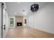 Bright living room with fireplace, hardwood floors, black trimmed windows, and modern black lighting fixture at 7528 E Windrose Dr, Scottsdale, AZ 85260