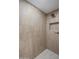 Walk-in shower featuring neutral toned tile and hexagonal tile floor at 7528 E Windrose Dr, Scottsdale, AZ 85260