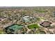 Aerial view of community amenities including a pool, tennis courts, and clubhouse surrounded by lush greenery at 8964 E Mountain Spring Rd, Scottsdale, AZ 85255