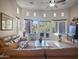 Spacious living room with travertine floors, high ceilings, and access to a private outdoor space at 8964 E Mountain Spring Rd, Scottsdale, AZ 85255