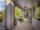 Covered patio with comfortable seating area and ceiling fan for outdoor relaxation overlooking the landscaped backyard at 8964 E Mountain Spring Rd, Scottsdale, AZ 85255