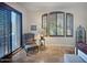 A comfortable sitting area with a large window with louvers and sliding doors for outdoor access and natural light at 8964 E Mountain Spring Rd, Scottsdale, AZ 85255