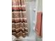 Bathroom featuring white shower stall and colorful desert themed shower curtain at 907 E Lancaster Cir, Florence, AZ 85132
