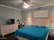 Comfortable bedroom with ceiling fan, accent lighting, and a white dresser at 907 E Lancaster Cir, Florence, AZ 85132