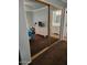 Bedroom featuring neutral walls, a workspace, and mirrored closet doors at 907 E Lancaster Cir, Florence, AZ 85132