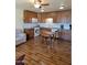 Open kitchen featuring natural light, wood cabinets and a dining table at 907 E Lancaster Cir, Florence, AZ 85132