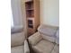 Comfortable living room featuring hardwood floors, neutral-toned furniture, and ample natural light at 907 E Lancaster Cir, Florence, AZ 85132