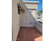 Enclosed patio area featuring a white exterior and terracotta tile flooring at 907 E Lancaster Cir, Florence, AZ 85132