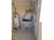 Utility storage with shelving, work surface, and hot water heater at 907 E Lancaster Cir, Florence, AZ 85132