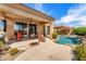 Backyard patio featuring a fire pit, seating, BBQ and pool with spa at 9327 E Whitewing Dr, Scottsdale, AZ 85262