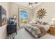 Comfortable bedroom featuring a ceiling fan and view of outdoor foliage at 9327 E Whitewing Dr, Scottsdale, AZ 85262