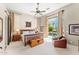 Serene bedroom featuring a king-size bed, a ceiling fan, and sliding doors leading to the pool and backyard oasis at 9327 E Whitewing Dr, Scottsdale, AZ 85262