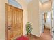 Inviting entryway featuring a wooden door, tile flooring, and neutral paint, creating a warm ambiance at 9327 E Whitewing Dr, Scottsdale, AZ 85262