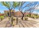 Charming home featuring desert landscaping, a tile roof, and mature trees providing ample shade at 9327 E Whitewing Dr, Scottsdale, AZ 85262