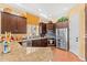Gourmet kitchen featuring granite countertops, stainless steel appliances, and dark wood cabinets at 9327 E Whitewing Dr, Scottsdale, AZ 85262