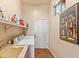 Practical laundry room with a utility sink and ample storage space for laundry essentials and household needs at 9327 E Whitewing Dr, Scottsdale, AZ 85262