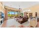 Bright living room featuring a ceiling fan, large windows with backyard views, and a comfortable seating arrangement at 9327 E Whitewing Dr, Scottsdale, AZ 85262