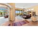 Cozy living area with sliding glass doors to the patio, tile accents, and comfortable seating arrangement at 9327 E Whitewing Dr, Scottsdale, AZ 85262