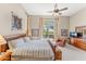 Cozy bedroom showcasing a king-size bed, a ceiling fan, and picturesque views of the pool and lush backyard at 9327 E Whitewing Dr, Scottsdale, AZ 85262