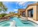 Beautiful backyard oasis showcasing a swimming pool, spa, covered patio, and well-manicured landscaping at 9327 E Whitewing Dr, Scottsdale, AZ 85262