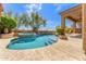 Swimming pool and spa with a stone waterfall feature and beautiful landscaping at 9327 E Whitewing Dr, Scottsdale, AZ 85262