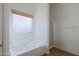Bathroom with a soaking tub under a window and a separate glass-enclosed shower at 9541 W Frank Ave, Peoria, AZ 85382