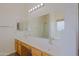 Bright bathroom with double sink vanity, large mirror, and a separate shower at 9541 W Frank Ave, Peoria, AZ 85382