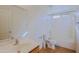 Bathroom with a single sink vanity, large mirror, toilet and shower over tub at 9541 W Frank Ave, Peoria, AZ 85382