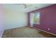 Bright bedroom featuring a ceiling fan and a window, with an accent wall in purple at 9541 W Frank Ave, Peoria, AZ 85382