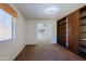 Bedroom with carpeted floors, a large window, and built-in shelving at 9541 W Frank Ave, Peoria, AZ 85382