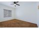 Neutral bedroom featuring a ceiling fan, a window with blinds and neutral walls at 9541 W Frank Ave, Peoria, AZ 85382