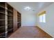 Bright bedroom featuring built-in shelves, carpet floors, and a window with a sunny view at 9541 W Frank Ave, Peoria, AZ 85382