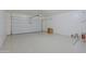 Spacious garage with a clean epoxy floor and ample storage area at 9541 W Frank Ave, Peoria, AZ 85382
