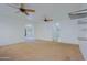 A bright room with ceiling fans, carpeted floor, and open doorway at 9541 W Frank Ave, Peoria, AZ 85382