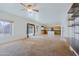 Spacious living room with natural light, ceiling fan, and kitchen view at 9541 W Frank Ave, Peoria, AZ 85382