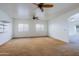 Living area showcasing carpeted floors and views of connecting rooms at 9541 W Frank Ave, Peoria, AZ 85382