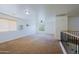 Upstairs living room featuring carpet, a white wall, ceiling fan and wood and metal railing at 9541 W Frank Ave, Peoria, AZ 85382
