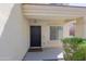 Covered porch with a black front door, matching hardware, and a small window on the side at 9541 W Frank Ave, Peoria, AZ 85382