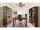 Spacious home office with modern desk, shelving units, and a comfortable chair, perfect for working from home at 10325 W Sands Dr # 456, Peoria, AZ 85383