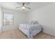 Cozy bedroom with a ceiling fan, a large window, and a comfortable bed with patterned linens at 17808 N 45Th Ave, Glendale, AZ 85308